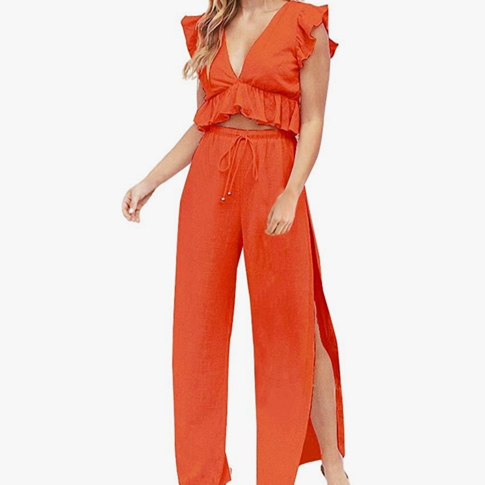 Bright orange set crop top and high waisted pants with side slits